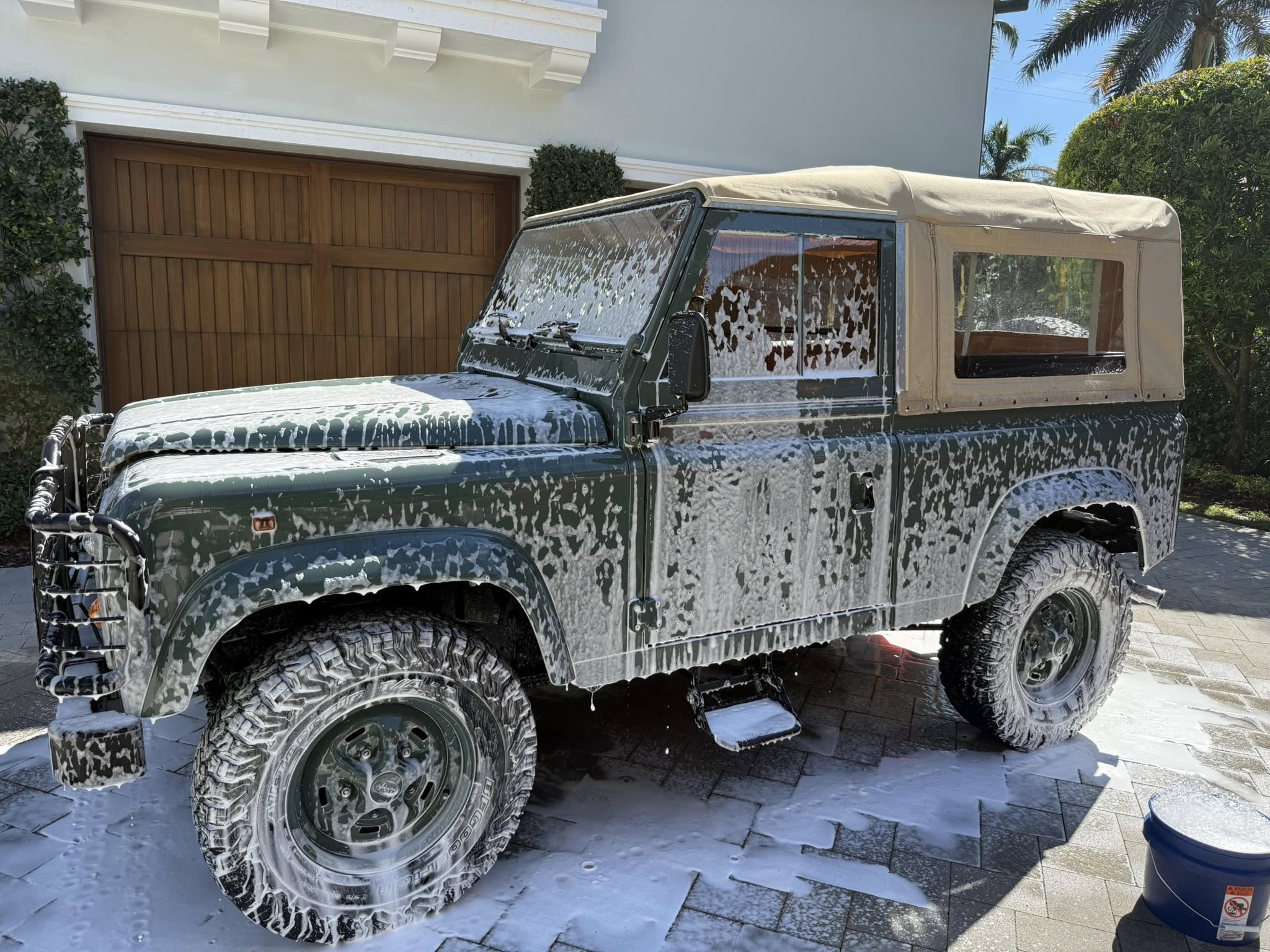 Luxury black car paint reflecting sunlight after correction